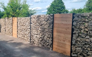 Gabion Fencing System and Gabion Baskets for retained driveway and privacy fence. Cotswold stone