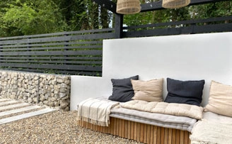 Modern seating area with gabion black timber and rendered boundary wall