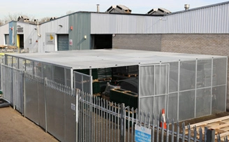 Large outdoor security cage for warehouse stock overflow. Large outdoor security cage for warehouse stock overflow.