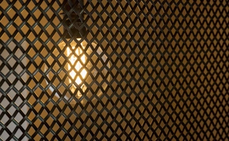 Tv components hidden behind industrial mesh, with industrial pendant backlight Tv components hidden behind industrial mesh, with industrial pendant backlight