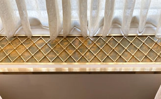 Brass Regency Diamond grille inserts for walls and window seat.