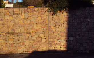 Retained gabion wall by roadside, Granite infill. Retained gabion wall by roadside, Granite infill.